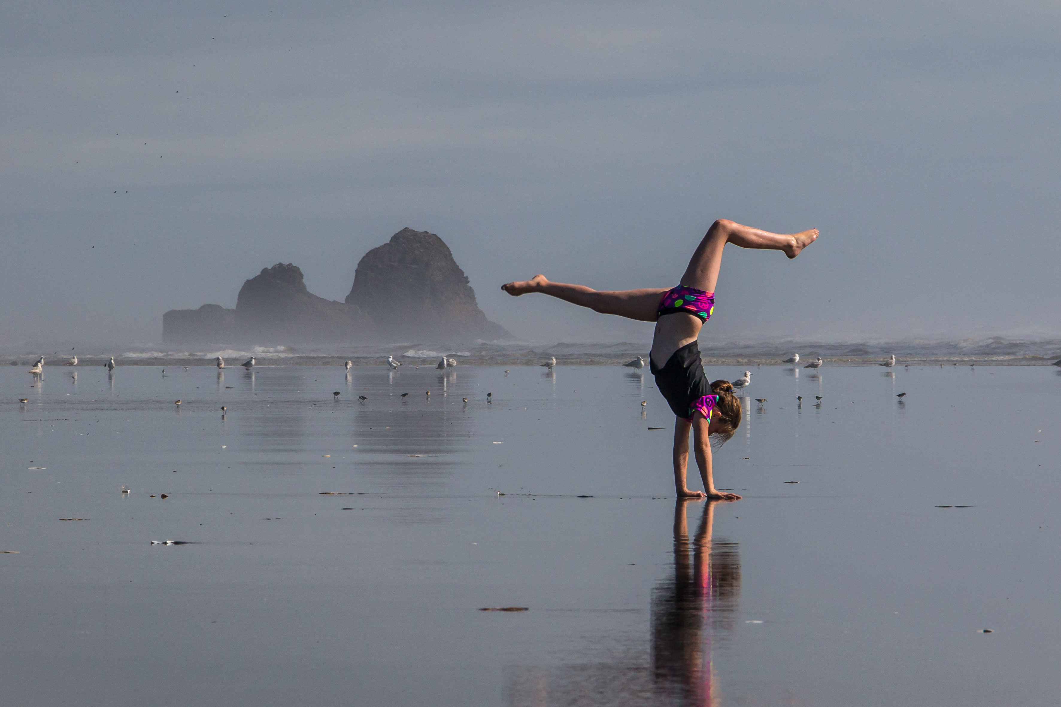 Hand-standing on the coast